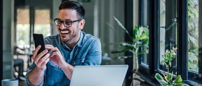 Enthusiastic adult man, getting good news in the middle of work.