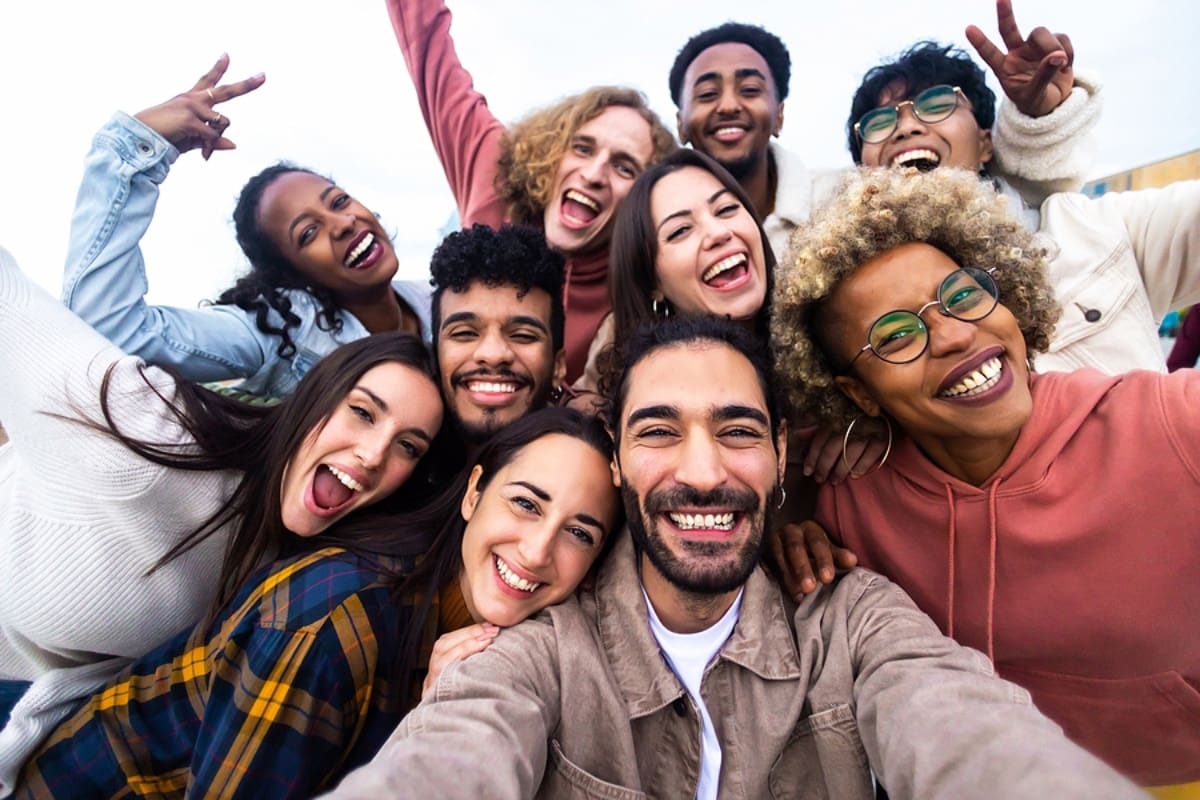 Big group portrait of diverse young people together outdoors