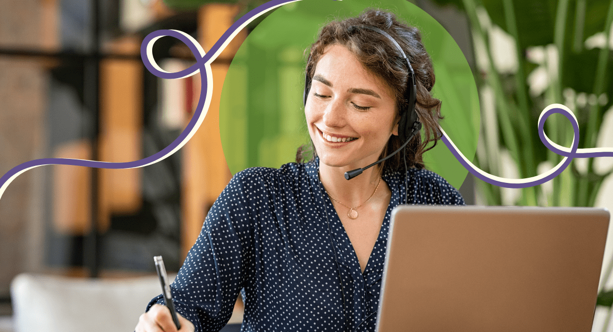 woman with headphones writing with pen, laptop in front of her