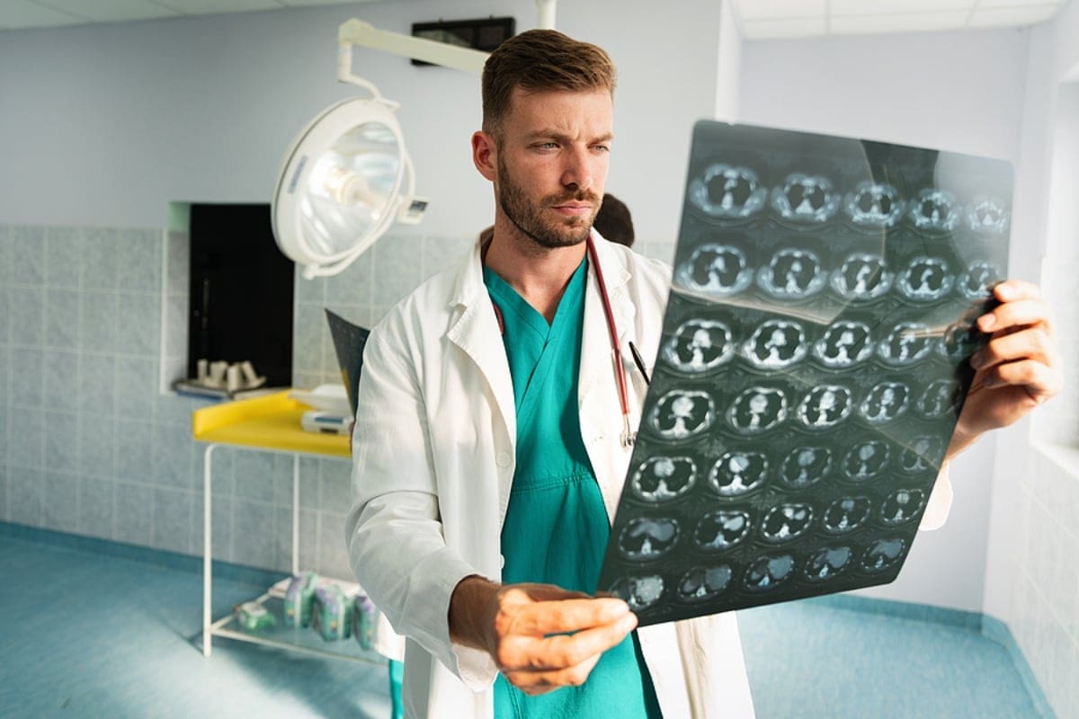 Radiologist, doctor examining x-ray images of patient for diagnosis