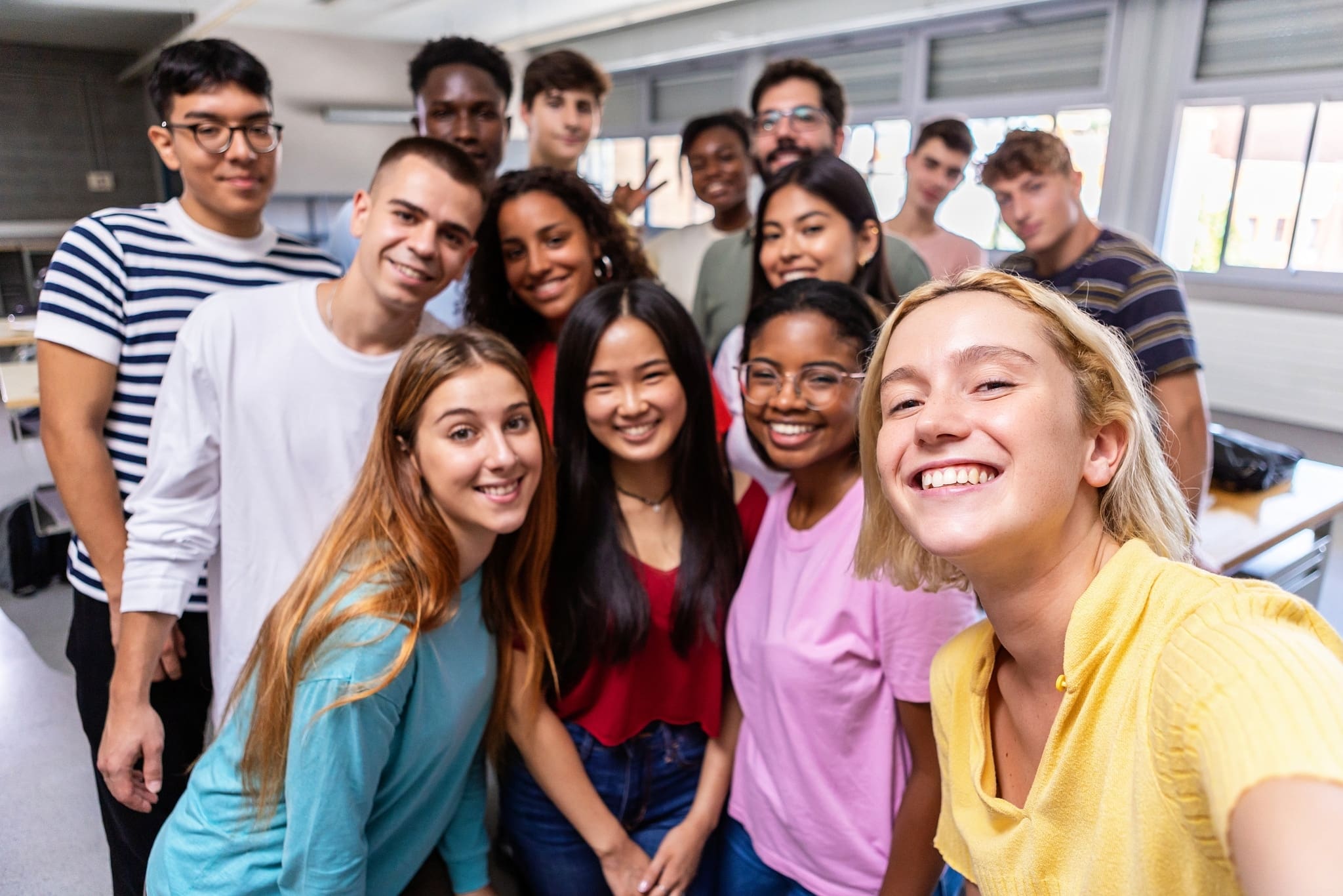 United multiracial big group of student friends taking selfie with teacher at college