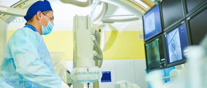 Interventional radiologist at operation during catheter based treatment with X-ray visualization.