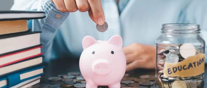 Piggy bank with books and jar of coins