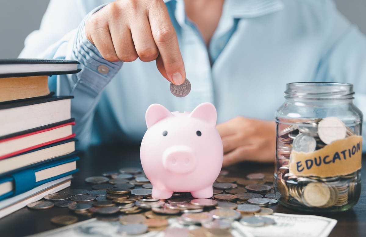 Piggy bank with books and jar of coins