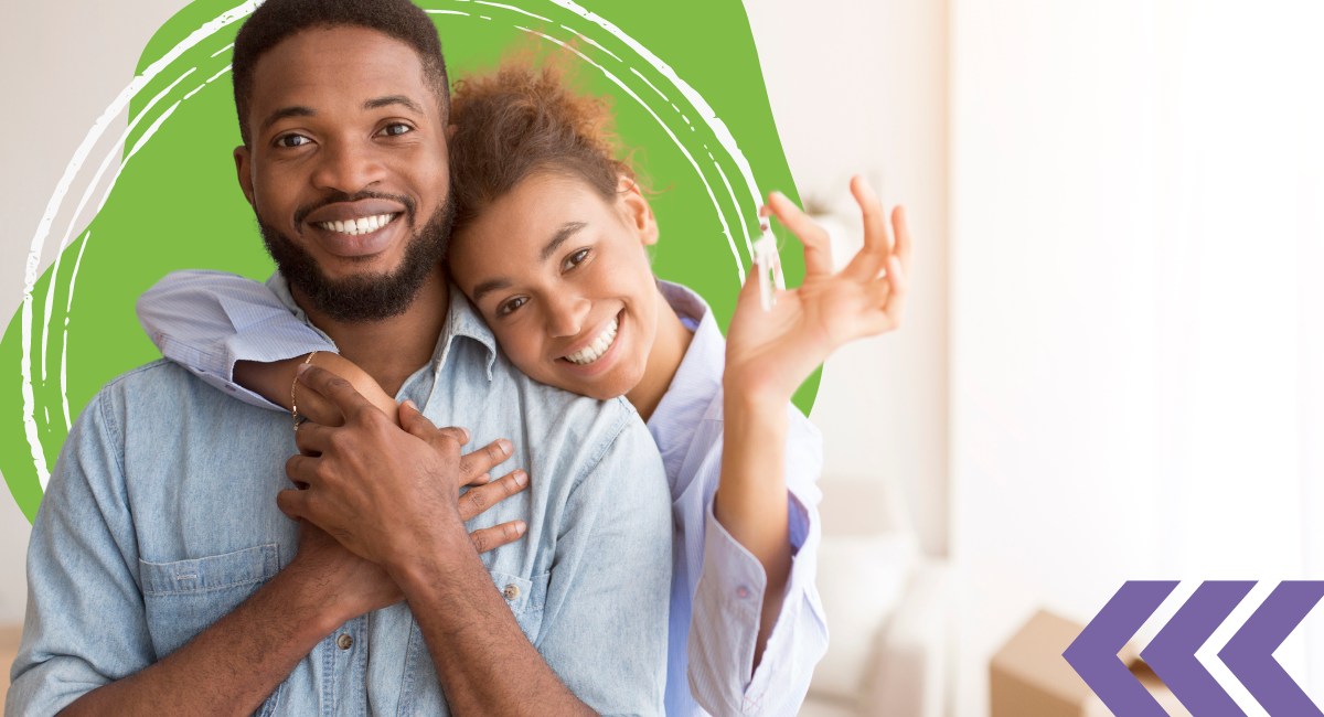 A couple holding a new house key