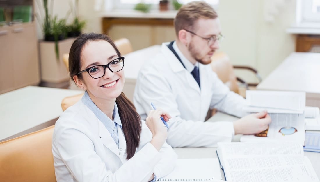 young general practitioner professional doctor in white coat discussing diagnosis in library.