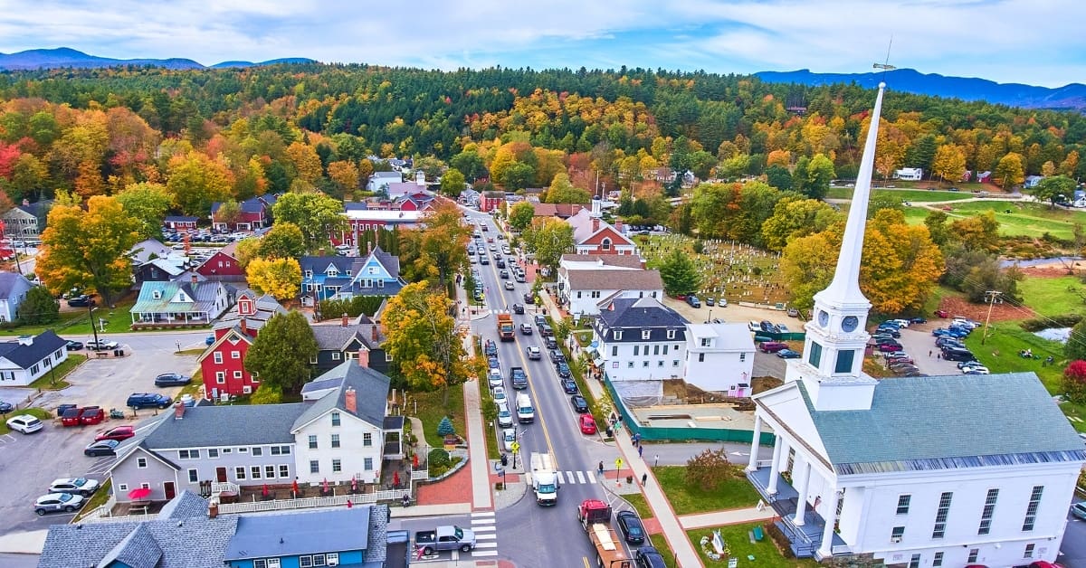 Church aerial in small town of Stowe, Vermont during peak fall foliage