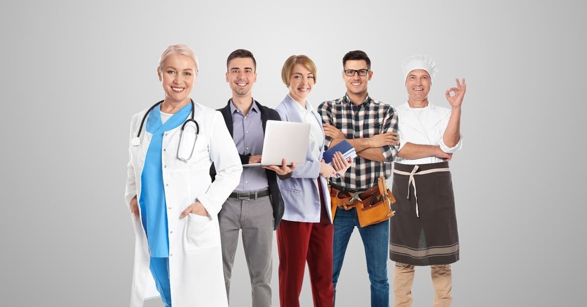 People of different occupations standing against a gray wall