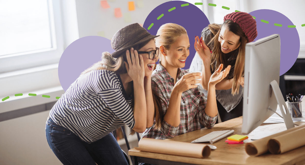 three female college students looking at laptop with surprise and happy cheers