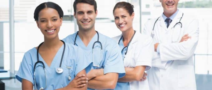 Portrait of confident doctors in row at medical office