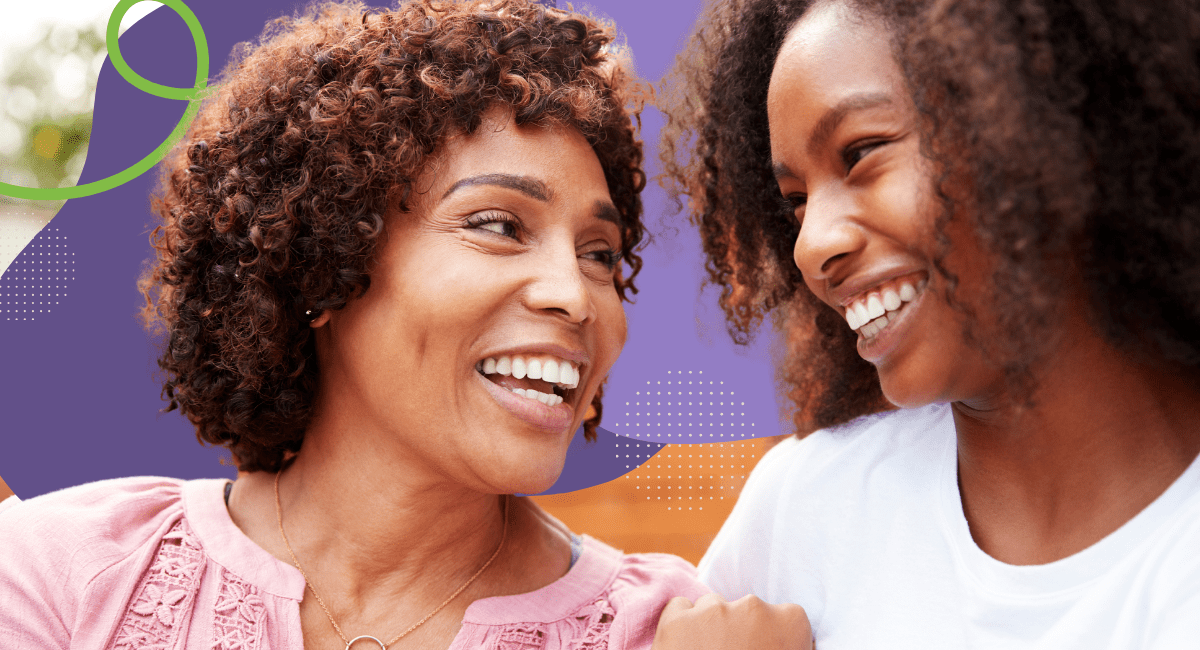 A mother and daughter smiling at each other