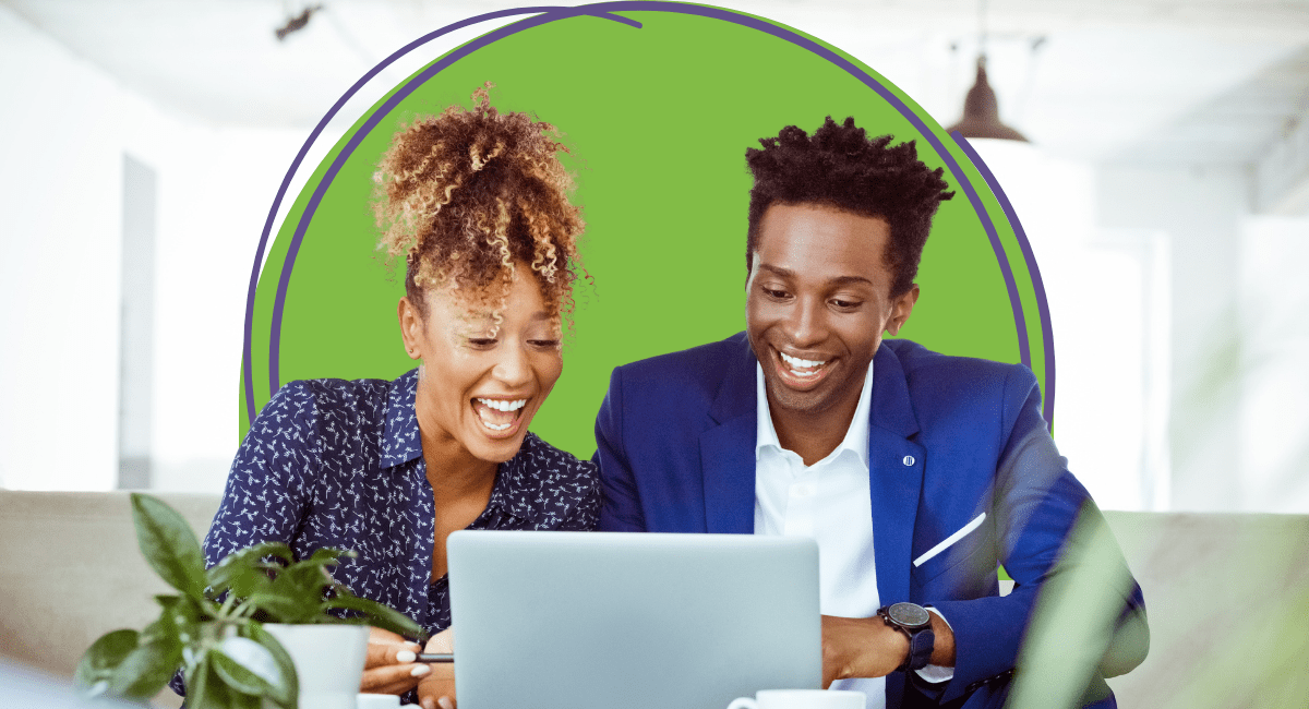 two officers workers smiling very big looking at laptop