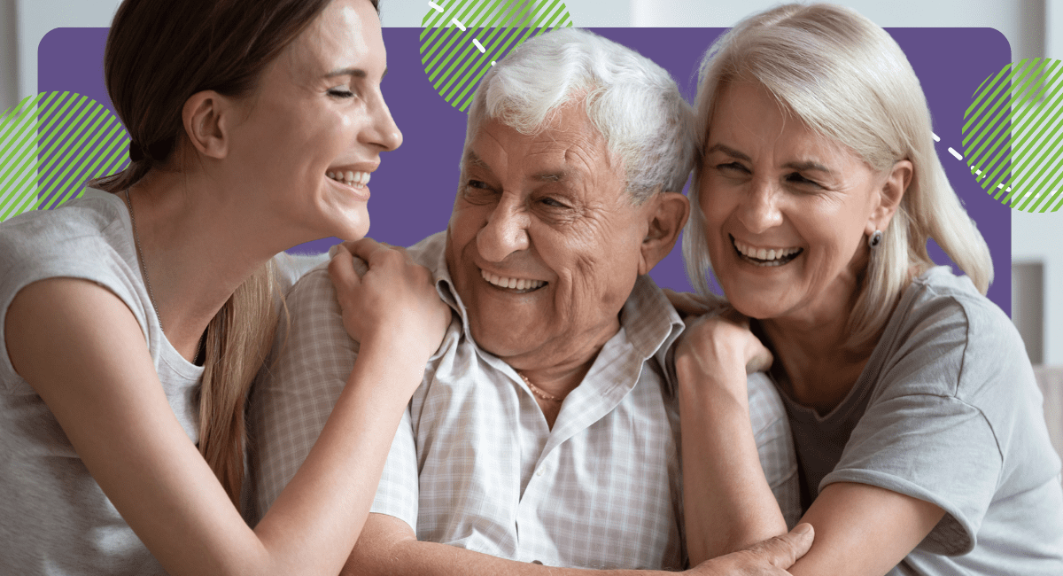 older couple with their daughter holding each other smiling very happily