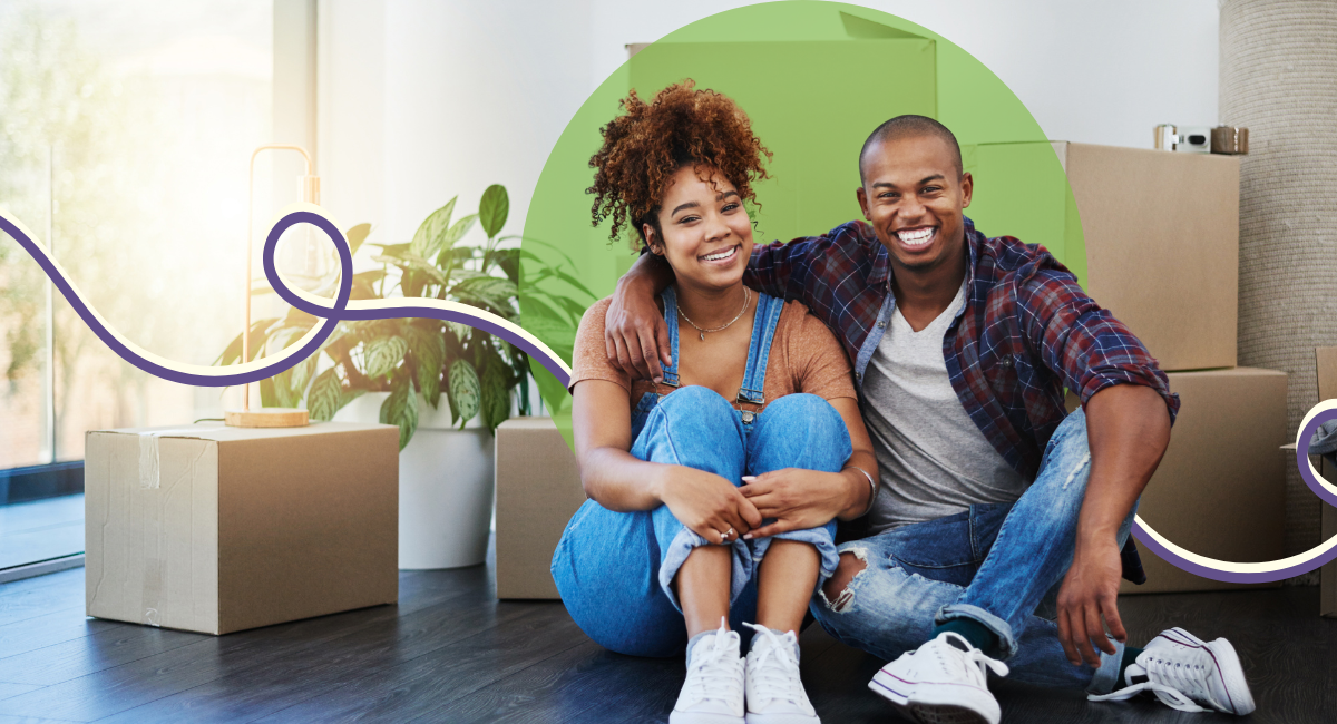 a young couple smiling very big, looking happy, after moving in to a new house