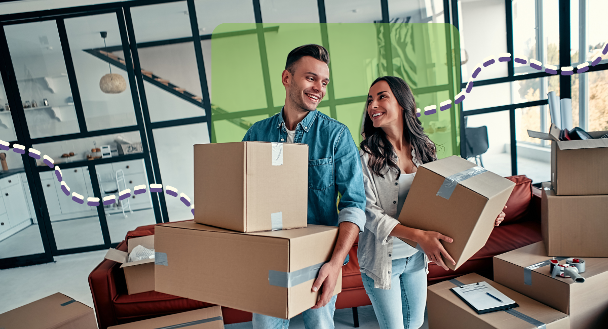 Couple Carrying Boxes Into New Home On Moving Day