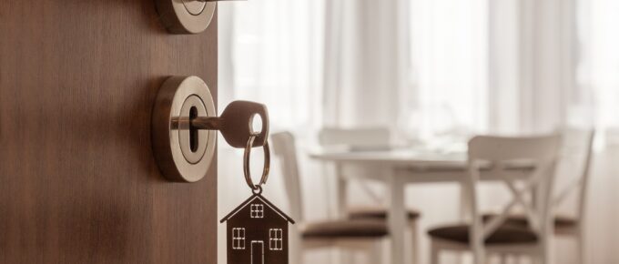 Door handle with key and home shaped keychain.