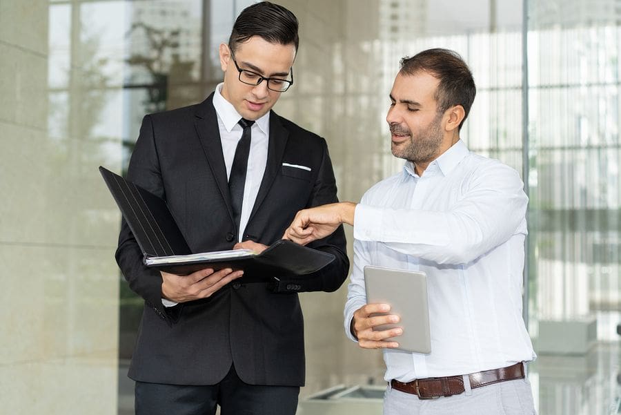 young male lawyer in suite talking to client