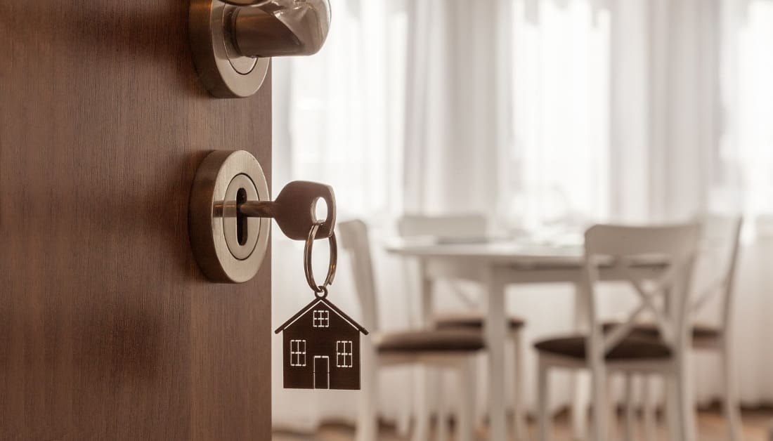 Door handle with key and home shaped keychain.