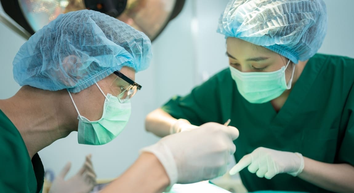 Asian Professional surgeons team performing surgery in the operating room