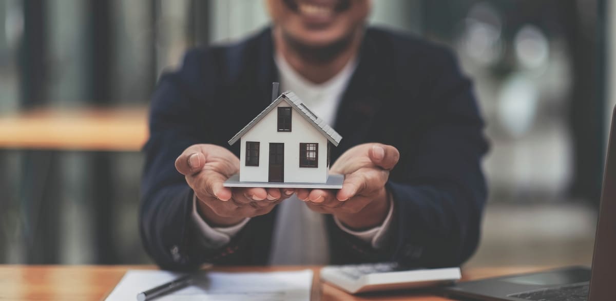 Business man hands holding modern house