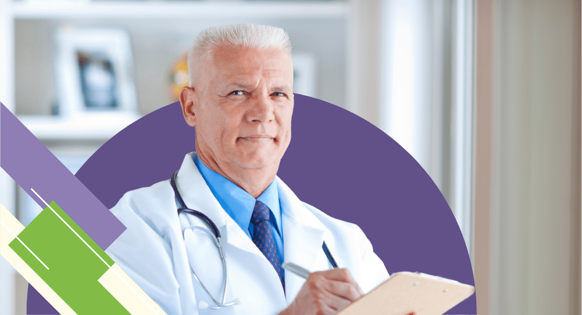 male physician holding clipboard, stethoscope on him and looking proud