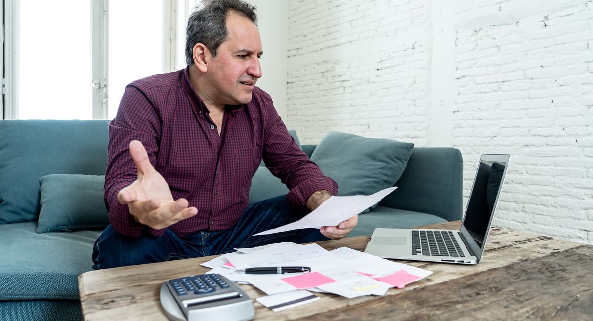 Worried and desperate mature man asking for help in paying student loan payments