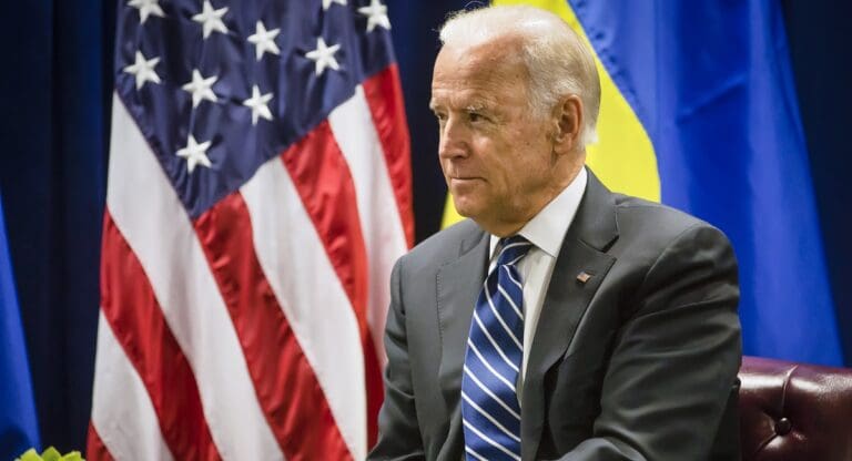 President Joe Biden sitting in a chair during a meeting
