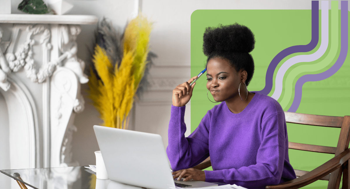 female with curly black hair looking at her laptop thinking deeply