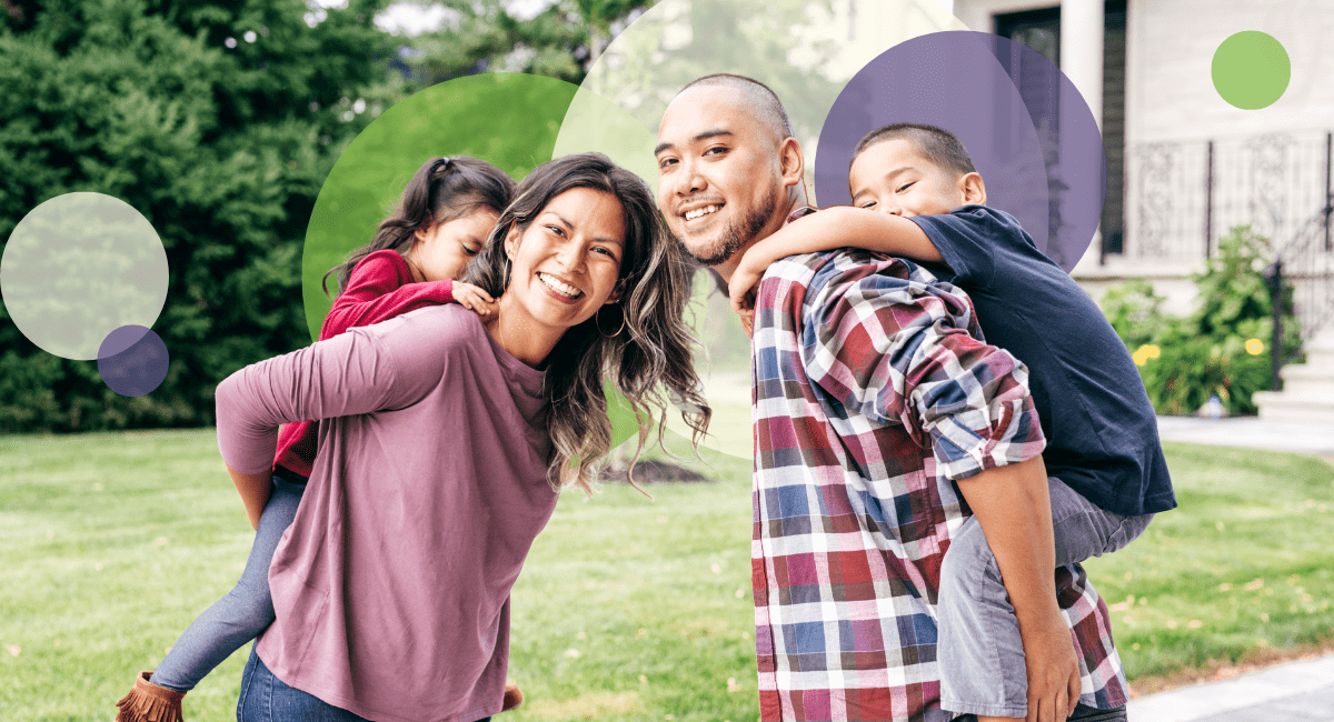 couple and two children outside having a good time, all smiling