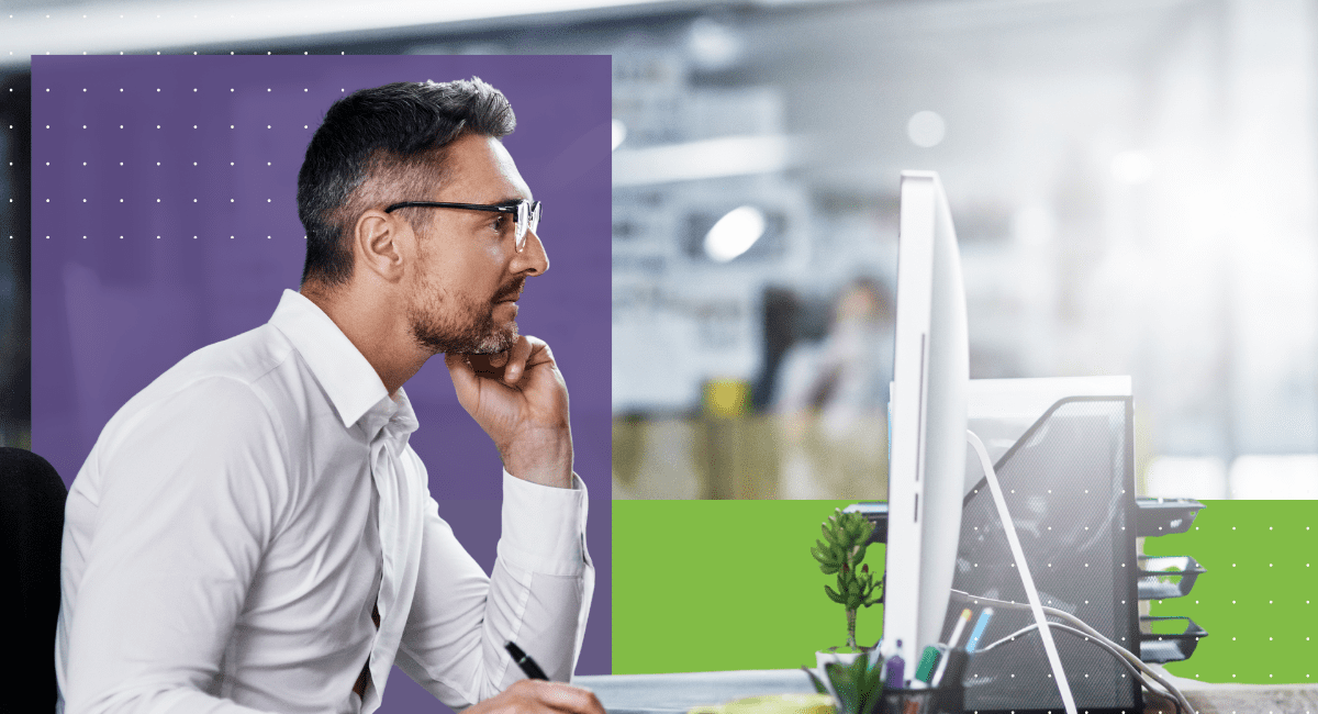 male worker with glasses looking at laptop, thinking deeply