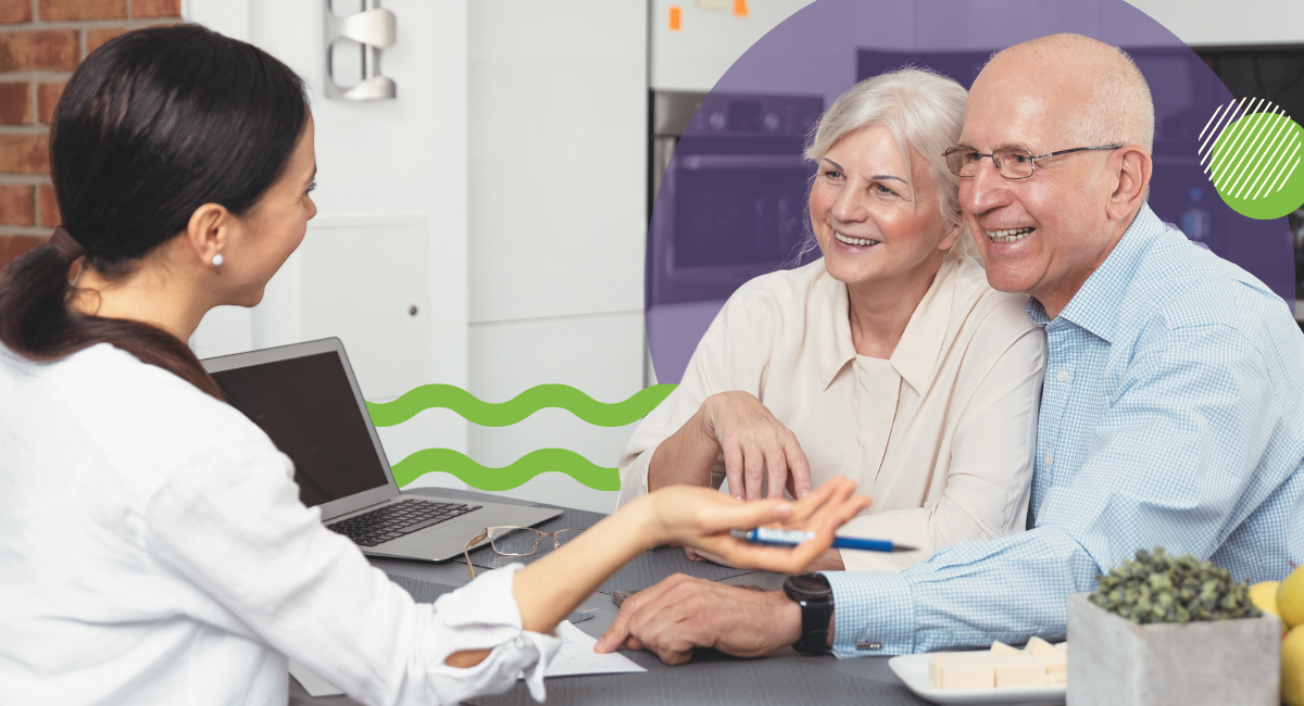 older couple sitting at a desk talking to a woman with dark hair