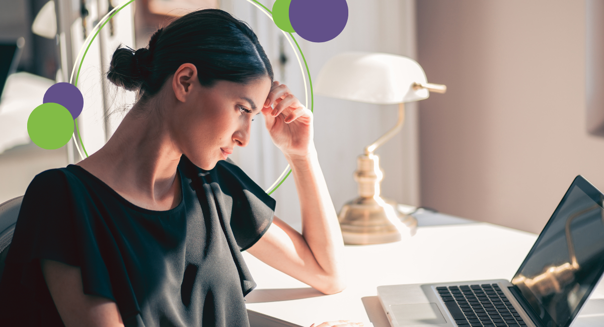 female sitting in front of laptop, thinking, worried looking