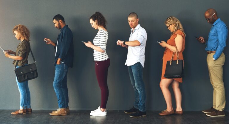 Line of people waiting, looking at their watch/phones/etc