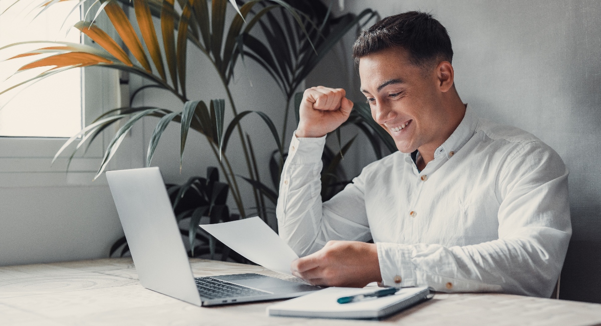 A business man happy about student loan payment.